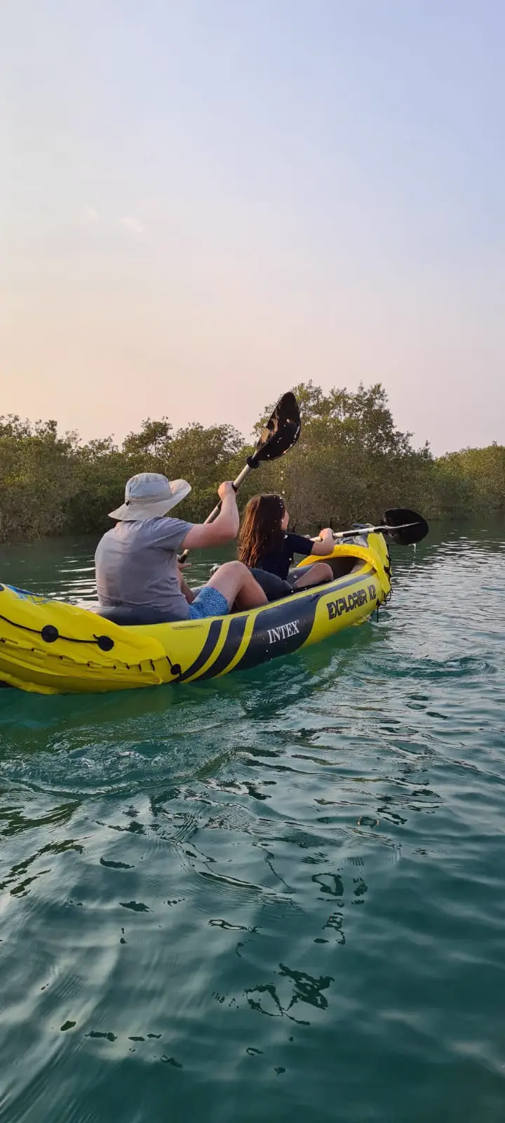 Paddling a kayak out through the mangroves at dusk