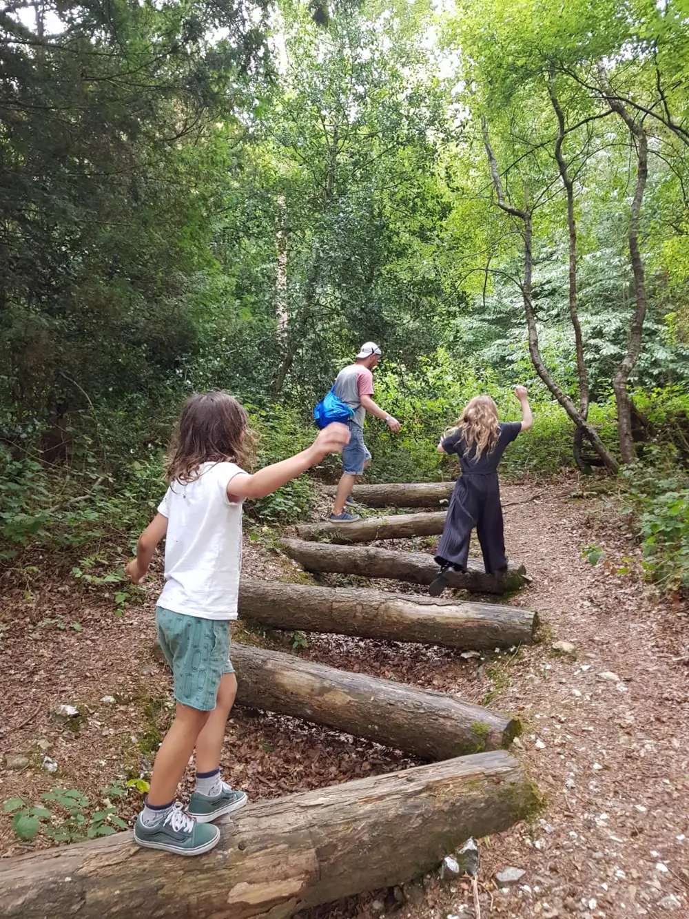 Climbing a run of log steps through the woods on a walk together