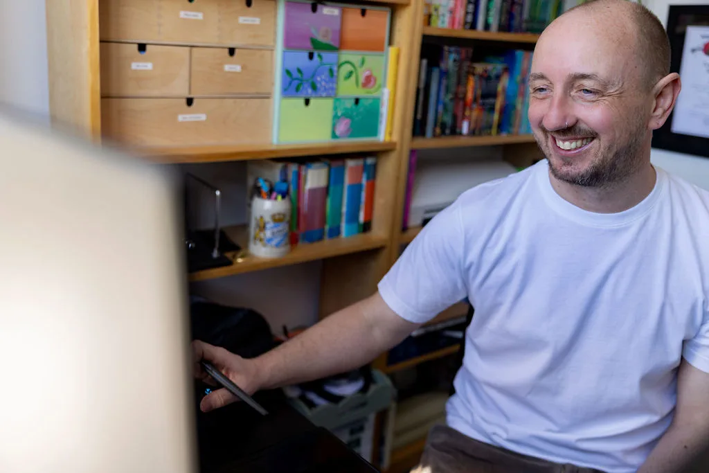 Rob smiling at his desk